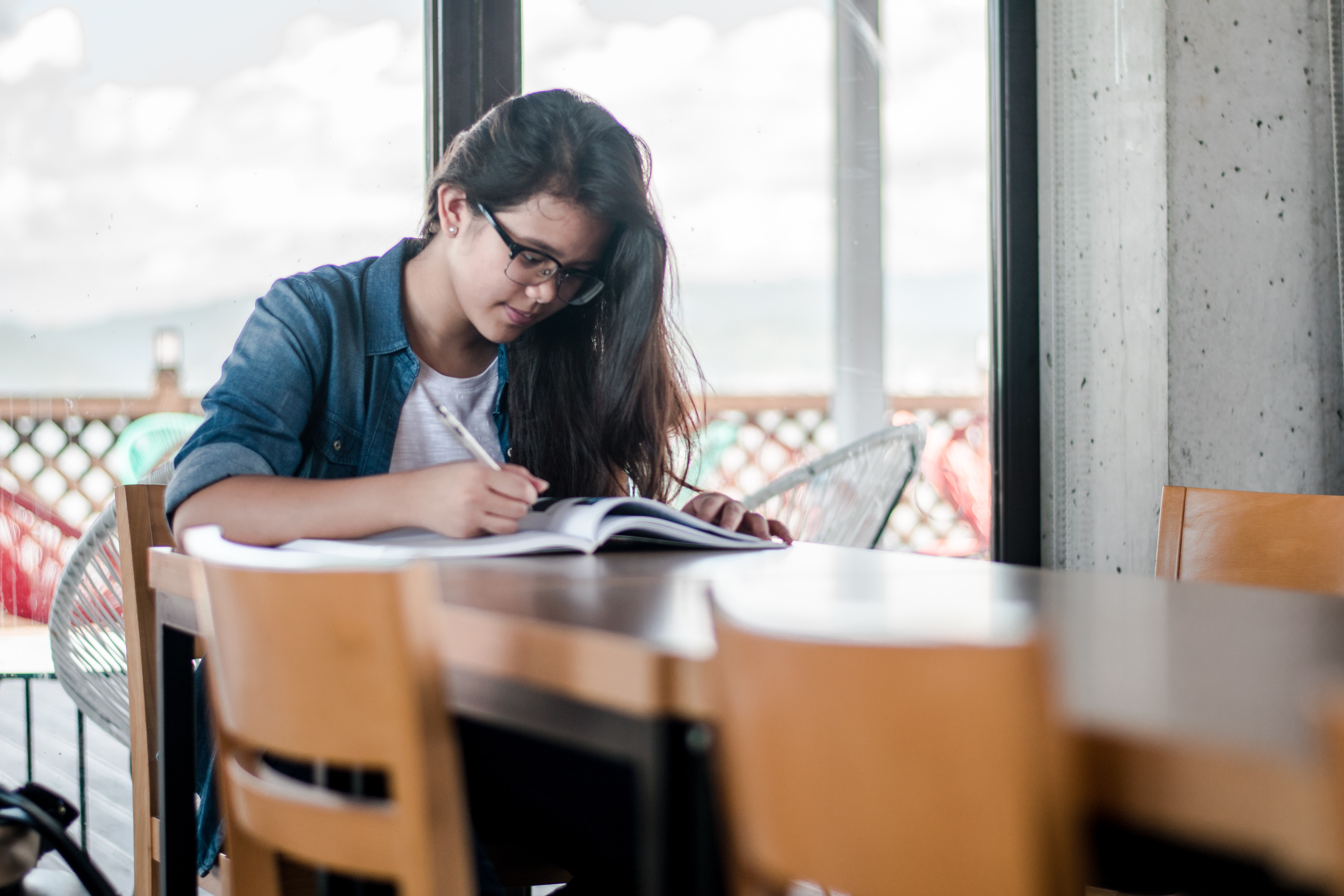 How can business schools attract women to their programs?